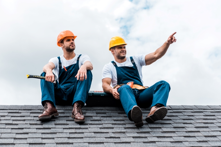 happy-handyman-pointing-with-finger-while-sitting-2023-11-27-05-30-40-utc